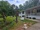 Landscaped front yard featuring cozy seating area and mature trees at 2799 Mockingbird Cir, Duluth, GA 30096