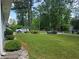 Well-manicured front yard featuring lush green grass and mature trees at 2799 Mockingbird Cir, Duluth, GA 30096