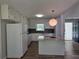White kitchen features granite countertops and an island with a cooktop at 2799 Mockingbird Cir, Duluth, GA 30096