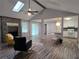 Open living room features a stone fireplace, skylight and ceiling fan at 2799 Mockingbird Cir, Duluth, GA 30096