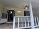 Inviting covered porch features stone flooring, ceiling fan, and exterior sconce lighting at 2799 Mockingbird Cir, Duluth, GA 30096