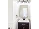 Stylish half-bathroom with elegant mirror, modern sink, and beautiful lighting at 3022 Kentmere Dr, Cumming, GA 30040