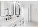 Modern bathroom features double vanity with black fixtures and stylish mirrors at 3022 Kentmere Dr, Cumming, GA 30040