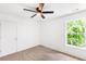 Bright bedroom with neutral carpet, a window with green view, and a ceiling fan at 3022 Kentmere Dr, Cumming, GA 30040