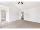 Large bedroom with attached bathroom and hallway, neutral carpet, and bright light at 3022 Kentmere Dr, Cumming, GA 30040