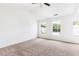 Bright bedroom with neutral carpet, windows, and a ceiling fan, offering ample space at 3022 Kentmere Dr, Cumming, GA 30040