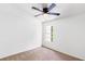 A cozy bedroom featuring neutral carpet, a ceiling fan, and a window for natural light at 3022 Kentmere Dr, Cumming, GA 30040