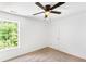 Bright bedroom features carpeted floors, a window with tree views, and a ceiling fan at 3022 Kentmere Dr, Cumming, GA 30040