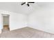 Spacious bedroom with neutral carpet, ceiling fan, and open doorway for easy access at 3022 Kentmere Dr, Cumming, GA 30040