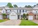 Charming two-story townhome with attached garage, well-maintained lawn, and inviting curb appeal at 3022 Kentmere Dr, Cumming, GA 30040