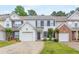 Charming two-story townhome with attached garage, well-maintained lawn, and inviting curb appeal at 3022 Kentmere Dr, Cumming, GA 30040