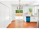 Modern kitchen and dining area featuring backyard access, granite counters and a bright blue dishwasher at 3022 Kentmere Dr, Cumming, GA 30040