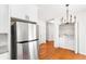 Well-lit kitchen area featuring stainless steel refrigerator and convenient access to the laundry area at 3022 Kentmere Dr, Cumming, GA 30040