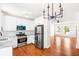 Modern kitchen flows into a spacious living area with hardwood floors at 3022 Kentmere Dr, Cumming, GA 30040