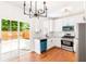 Modern kitchen with white cabinets, stainless steel appliances, and sliding doors to backyard at 3022 Kentmere Dr, Cumming, GA 30040