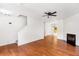 Open-concept living room with hardwood floors, fireplace, and staircase at 3022 Kentmere Dr, Cumming, GA 30040