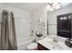 Clean bathroom with combined shower and tub, vanity with sink, and neutral decor at 4430 Cedar Bridge Walk, Suwanee, GA 30024