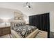 Cozy bedroom with a ceiling fan, a floral bed spread, and large art on the wall at 4430 Cedar Bridge Walk, Suwanee, GA 30024