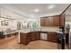 Open concept kitchen with stainless appliances, granite counters, bar seating, and hardwood floors at 4430 Cedar Bridge Walk, Suwanee, GA 30024