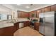 Well-equipped kitchen with stainless steel appliances, granite countertops, and wood cabinets at 4430 Cedar Bridge Walk, Suwanee, GA 30024