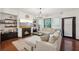 Cozy living room features a fireplace, plush seating, hardwood floors and lots of natural light at 4430 Cedar Bridge Walk, Suwanee, GA 30024