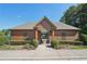 View of the neighborhood pool entrance with manicured shrubs and brown siding at 4430 Cedar Bridge Walk, Suwanee, GA 30024