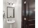 Clean powder room with pedestal sink, decorative mirror, and convenient location at 4430 Cedar Bridge Walk, Suwanee, GA 30024