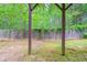 Backyard view through a wooden frame structure, showcasing trees, vegetation, and a wooden fence at 535 Pierpoint Dr, Atlanta, GA 30331