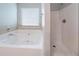 Well-lit bathroom with a soaking tub and walk-in shower offering relaxation and convenience at 535 Pierpoint Dr, Atlanta, GA 30331
