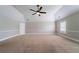 An empty room with neutral colors, a ceiling fan, and carpet flooring offers a versatile space for customization at 535 Pierpoint Dr, Atlanta, GA 30331