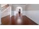Open dining room featuring hardwood floors, wainscoting, and archway to kitchen at 535 Pierpoint Dr, Atlanta, GA 30331
