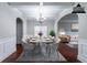 Dining room with hardwood floors, coffered ceiling, arched doorways, and virtually staged furniture at 535 Pierpoint Dr, Atlanta, GA 30331