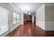 Open dining area featuring hardwood floors and view into kitchen and backyard at 535 Pierpoint Dr, Atlanta, GA 30331