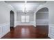 Open dining room with hardwood floors, arched doorways, coffered ceilings, and elegant chandelier at 535 Pierpoint Dr, Atlanta, GA 30331