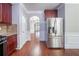 Well-lit kitchen featuring stainless steel refrigerator and access to the living room at 535 Pierpoint Dr, Atlanta, GA 30331