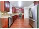 Well-lit kitchen with stainless steel appliances, granite countertops, and cherry wood cabinets at 535 Pierpoint Dr, Atlanta, GA 30331