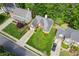 Aerial view of landscaped property with a brick home and two-car garage amid mature trees at 545 Creek Landing Ln, Alpharetta, GA 30005