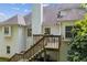 View of a backyard deck accessible by stairs with a white siding exterior and lovely outdoor space at 545 Creek Landing Ln, Alpharetta, GA 30005