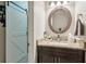 Charming bathroom with dark wood vanity, granite countertops, and a decorative mirror at 545 Creek Landing Ln, Alpharetta, GA 30005