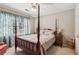Comfortable bedroom with a four-poster bed and soft lighting at 545 Creek Landing Ln, Alpharetta, GA 30005