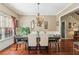 Inviting dining space with elegant chandelier, wainscoting detail, and hardwood flooring at 545 Creek Landing Ln, Alpharetta, GA 30005