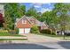 Lovely brick home with a well-maintained lawn, mature trees, and a spacious driveway at 545 Creek Landing Ln, Alpharetta, GA 30005