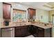 Kitchen area featuring wood cabinets, stainless steel appliances, and a window view at 545 Creek Landing Ln, Alpharetta, GA 30005