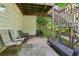 Outdoor patio area featuring multiple seating options and stairs to the yard, offering a relaxing space at 545 Creek Landing Ln, Alpharetta, GA 30005