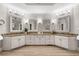 Bathroom features a double sink vanity with granite countertop and decorative mirrors at 560 Indigo Dr, Roswell, GA 30075