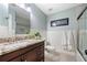 Bathroom features a dark wood vanity, white wainscoting, and a glass-enclosed shower at 560 Indigo Dr, Roswell, GA 30075
