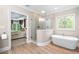Bathroom features a walk-in shower and a soaking tub, next to a decorative window at 560 Indigo Dr, Roswell, GA 30075