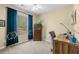 Cozy bedroom with a window view, a ceiling fan, and a carpeted floor offers a comfortable space at 560 Indigo Dr, Roswell, GA 30075