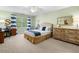 Bedroom features a ceiling fan, a large window, a desk, and a dresser at 560 Indigo Dr, Roswell, GA 30075