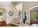 Bright foyer with hardwood floors, staircase and natural light at 560 Indigo Dr, Roswell, GA 30075